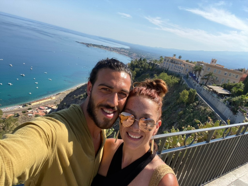 Monika and Alessio enjoying the scenic view over the coastline in Taormina, Sicily.